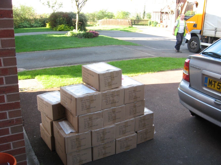 A pile of boxes on the street Description automatically generated