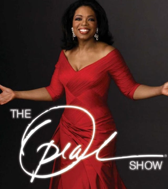 Image of Oprah Winfrey in a figure hugging red dress from the Oprah web site