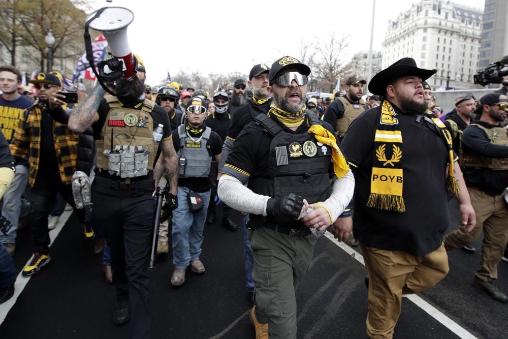 FILE - Supporters of President Donald Trump who are wearing attire associated with the Proud Boys attend a rally at Freedom Plaza, Dec. 12, 2020, in Washington. The supporter on the left is wearing a patch with red lettering that reads “RWDS,” which is short for “Right Wing Death Squad.” The gunman who killed eight people on Saturday, May 6, 2023, at a Dallas-area mall was wearing a “RWDS” patch as well. The phrase has been embraced in recent years by far-right extremists who glorify violence against their political enemies. (AP Photo/Luis M. Alvarez, File)