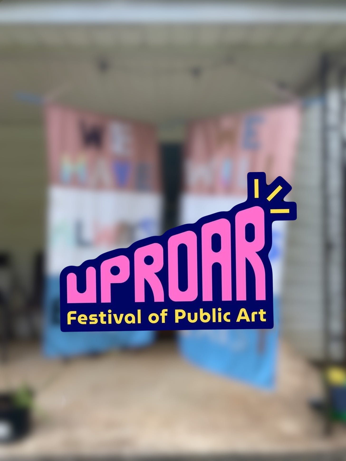 A blurred image of our artwork with the Uproar logo on top of it.