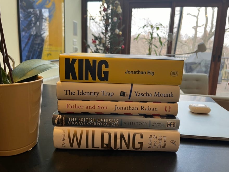 A stack of books on a table

Description automatically generated