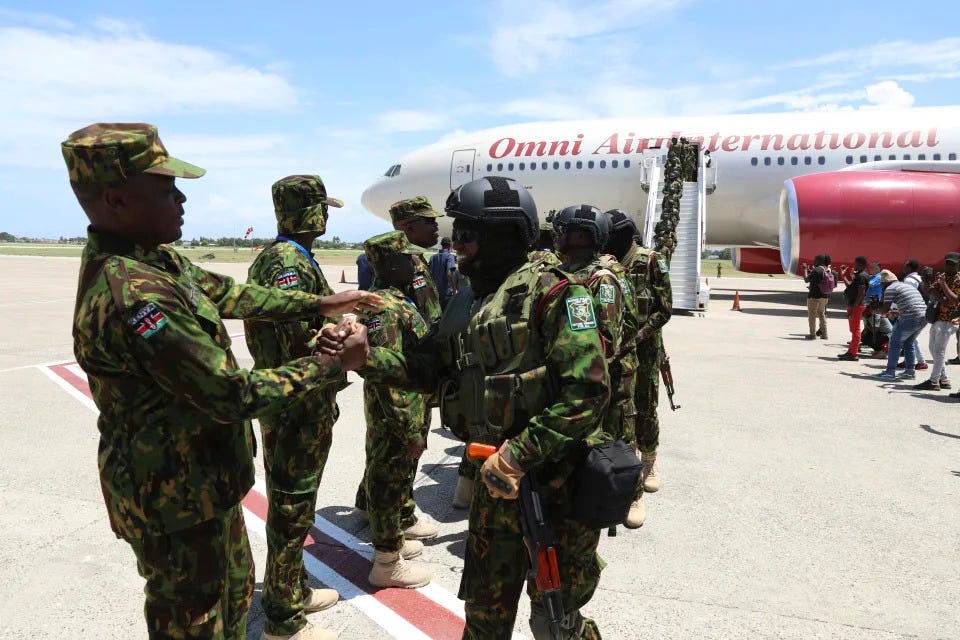 Kenyan police that are part of a UN-backed multinational force welcome more Kenyan police after their plane landed at Toussaint Louverture International Airport in Port-au-Prince, Haiti, Tuesday, July 16, 2024. Another 200 police officers from Kenya arrived for a U.N.-backed mission led by the East African country to battle violent gangs that have taken over parts of the Caribbean country. (AP Photo/Odelyn Joseph)