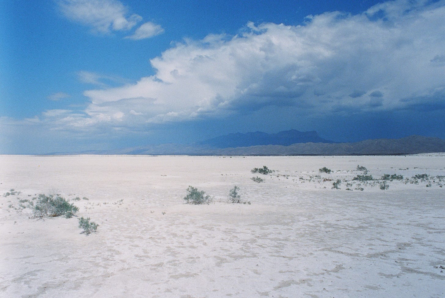 Guadalupe salt flats with storm clouds over the mountains