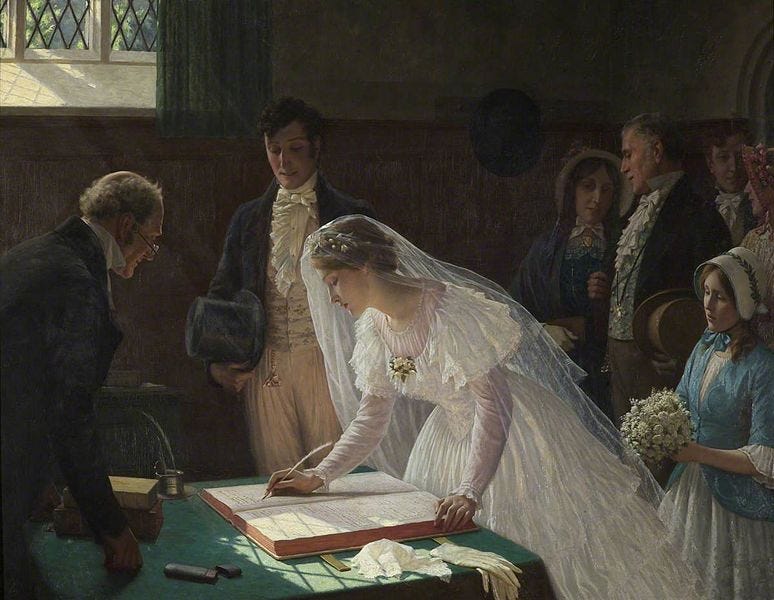 The bride leans over and signs the register book with a quill pen while groom and witnesses look on.