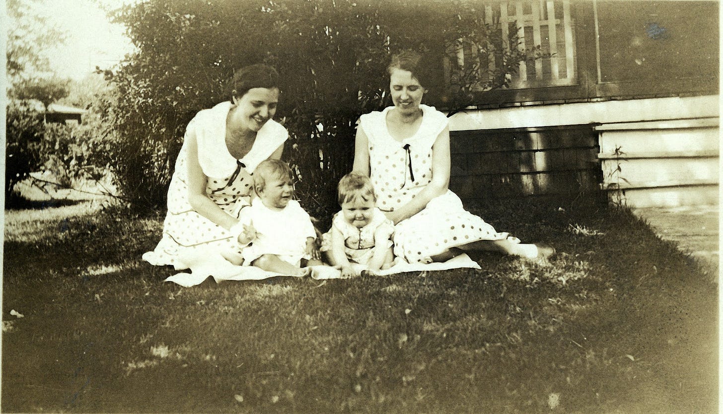 Two woman with children on lawn