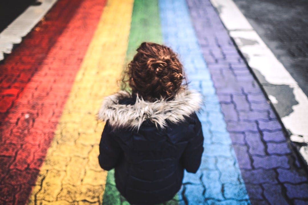 woman standing on multicolored concrete pavement during daytime woman standing on multicolored concrete pavement during daytime