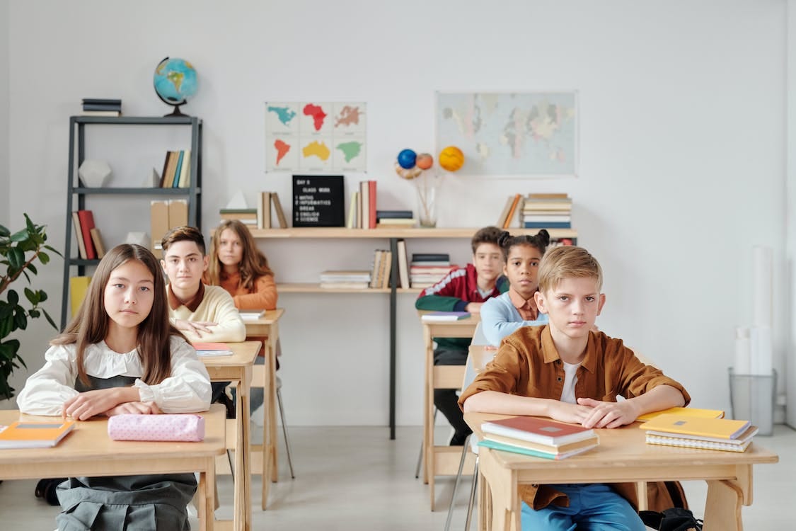 Free Kids Sitting Inside a Classroom Stock Photo