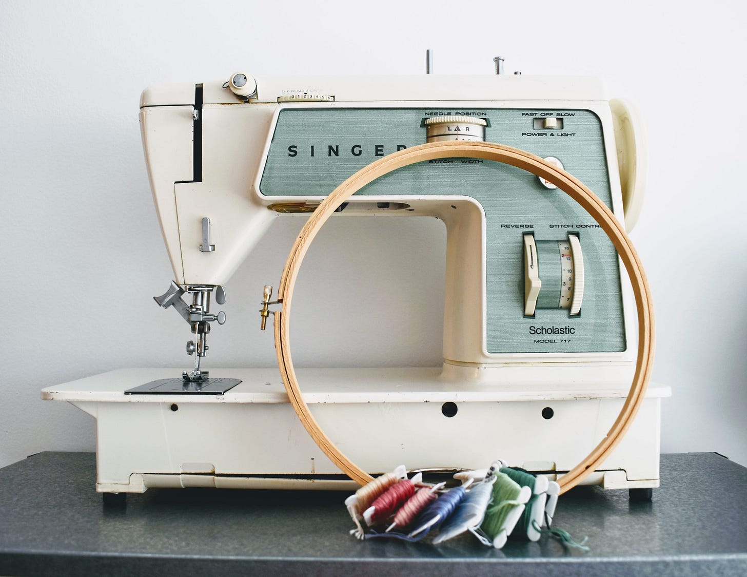 1960s-era Singer sewing machine pictured with embroidery supplies