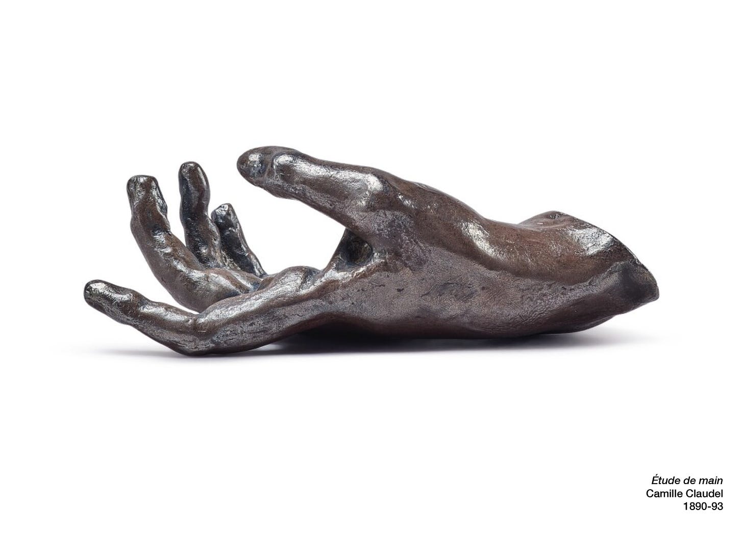 A bronze sculpture of a hand, palm up and fingers reaching out gently