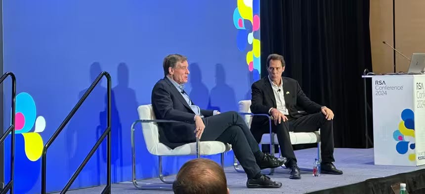 Senator Mark Warner, D-Va. (L) speaks with NightDragon Founder and CEO Dave DeWalt (R) at the 2024 RSA conference in San Francisco, California. Senator Mark Warner, D-Va. (L) speaks with NightDragon Founder and CEO Dave DeWalt (R) at the 2024 RSA conference in San Francisco, California.