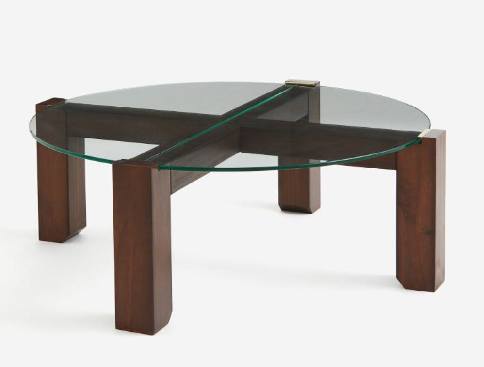 circular glass coffee table with dark wood legs