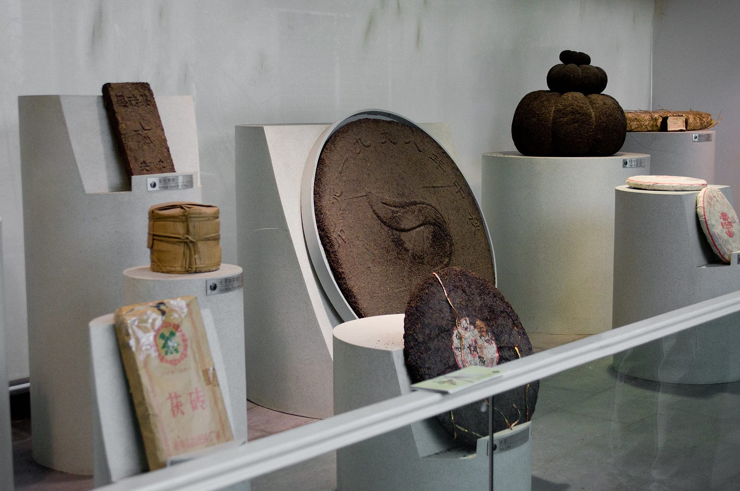 ID: Giant tea cakes in various shapes in a museum exhibit