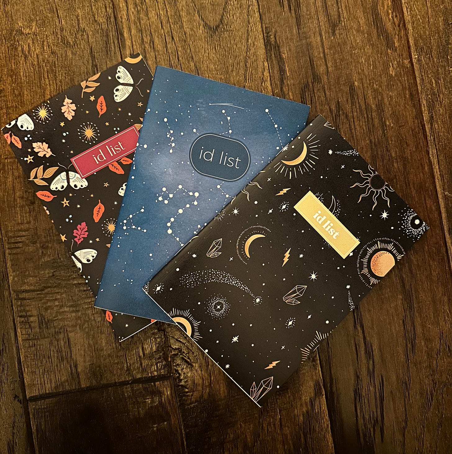 Three notebooks with various patterns on them and "id list" on each cover