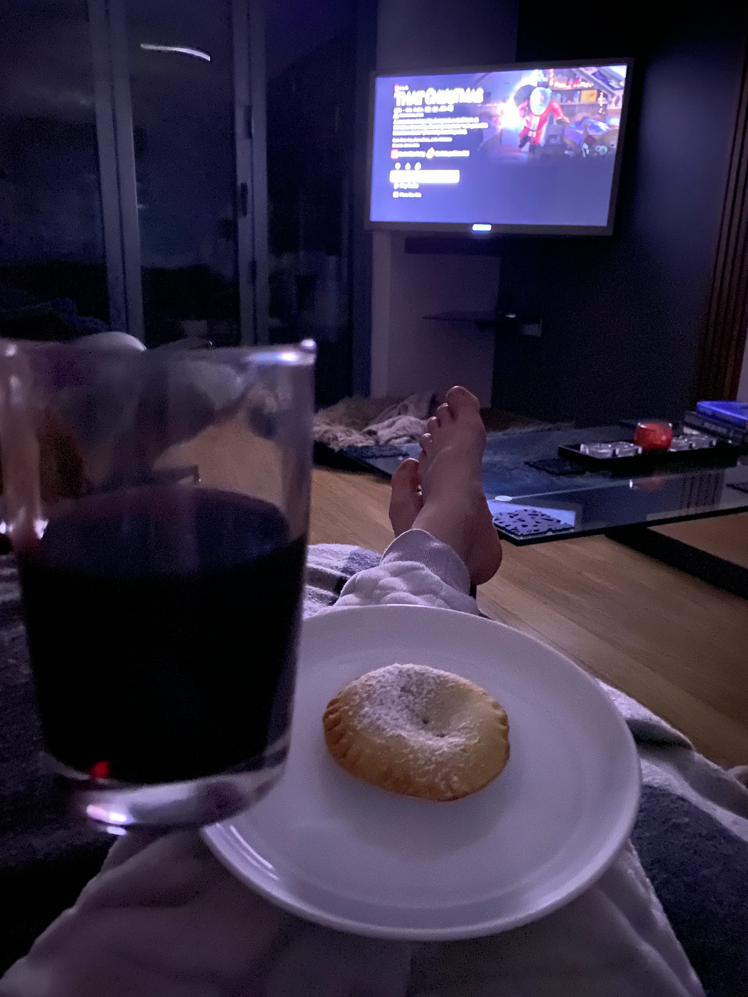 relaxing on the sofa with a mug of mulled wine and a mince pie watching television