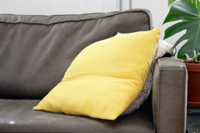 A living room couch with two pillows.
