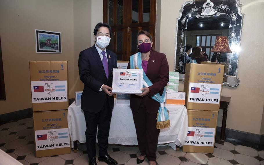 In this file photo provided by the Taiwan Presidential Office, Taiwan’s Vice President Lai Ching-te, left, presents an aid package, including oxygen concentrators, during a meeting with Honduran President Xiomara Castro in Tegucigalpa, Honduras, Thursday, Jan. 27, 2022. On Sunday, March 26, 2023, Chinese state media CCTV said that Honduras has cut diplomatic ties with Taiwan, paving the way for a relationship with Beijing.