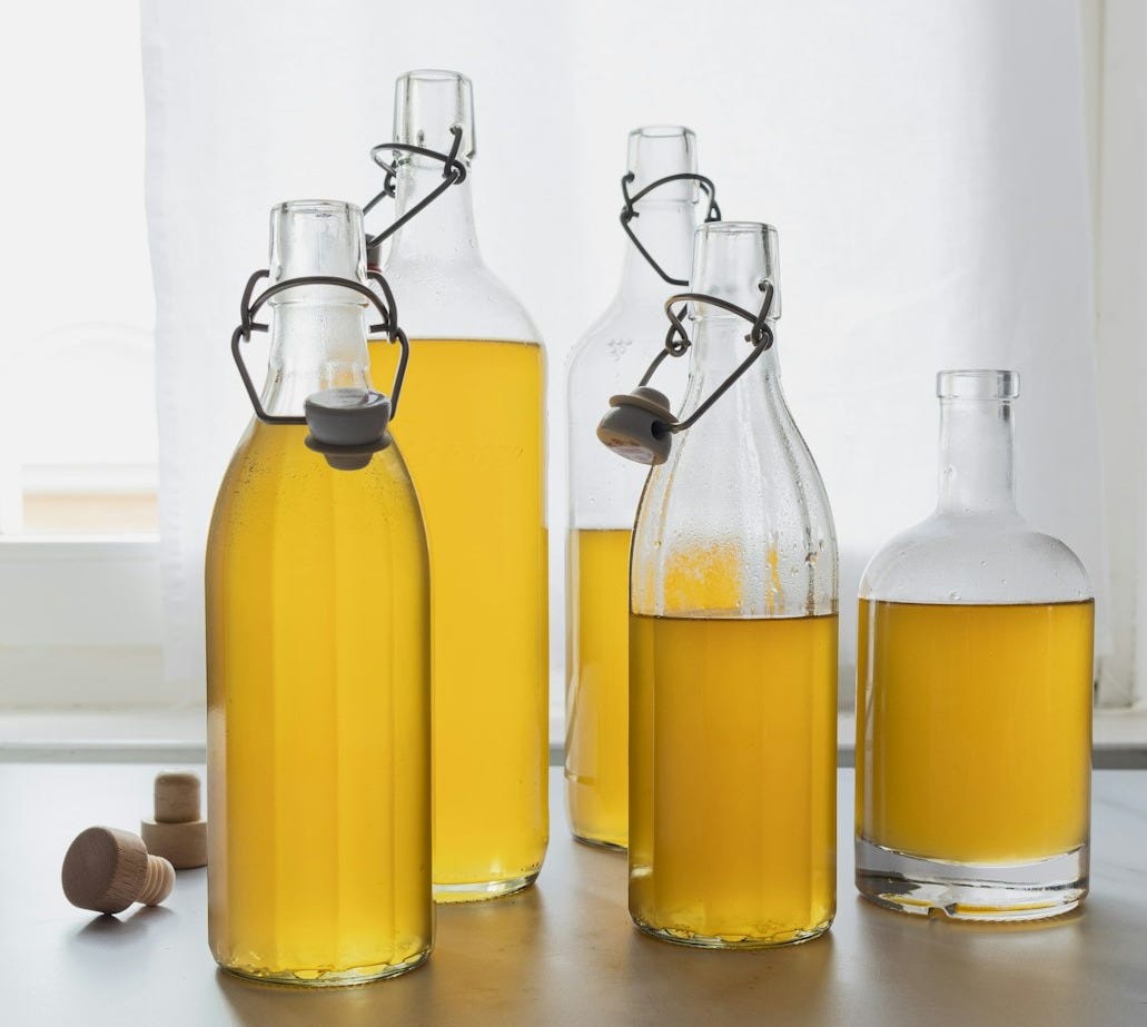 A group of bottles filled with yellow liquid