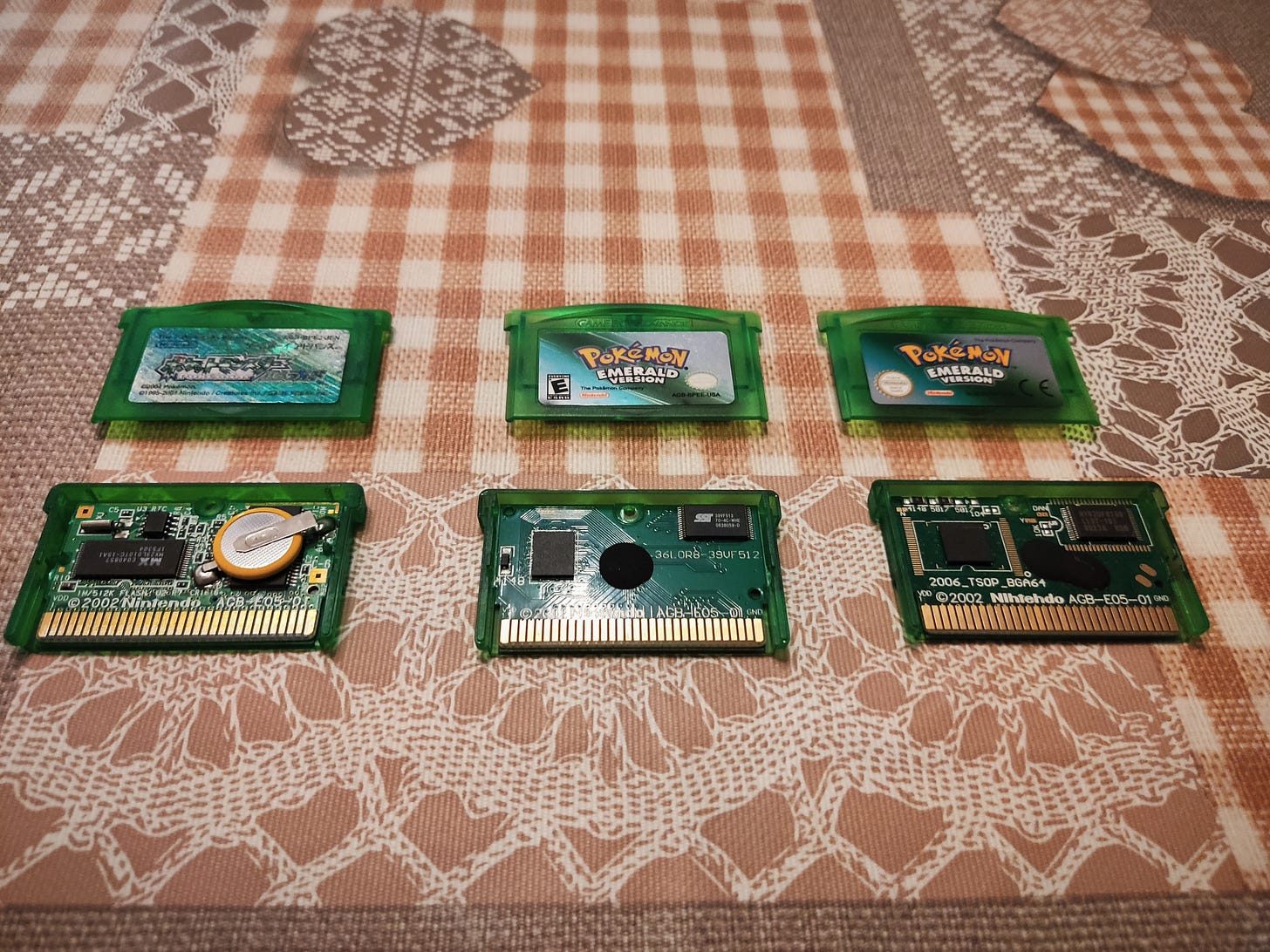 Copies of Pokémon Emerald. Left side is a genuine Japanese copy, centre is a reproduction, right side is also a reproduction (Photo credit: Lucent)