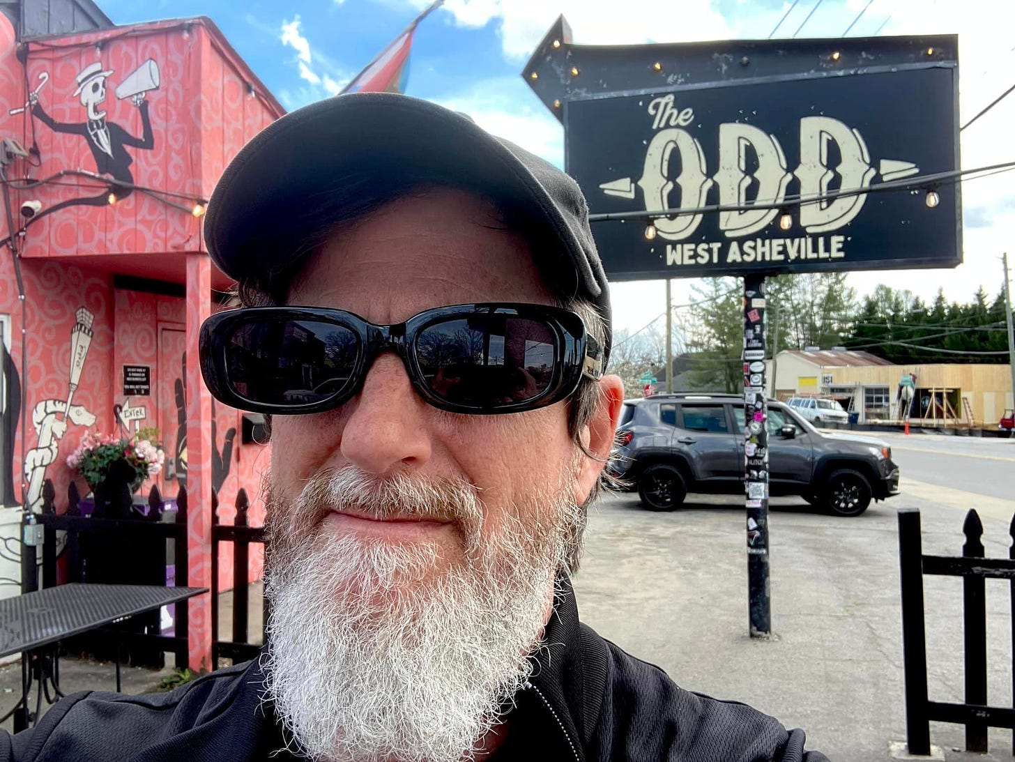 May be an image of 1 person, beard, outdoors and text that says 'The 0D.D WEST ASHEVILLE'
