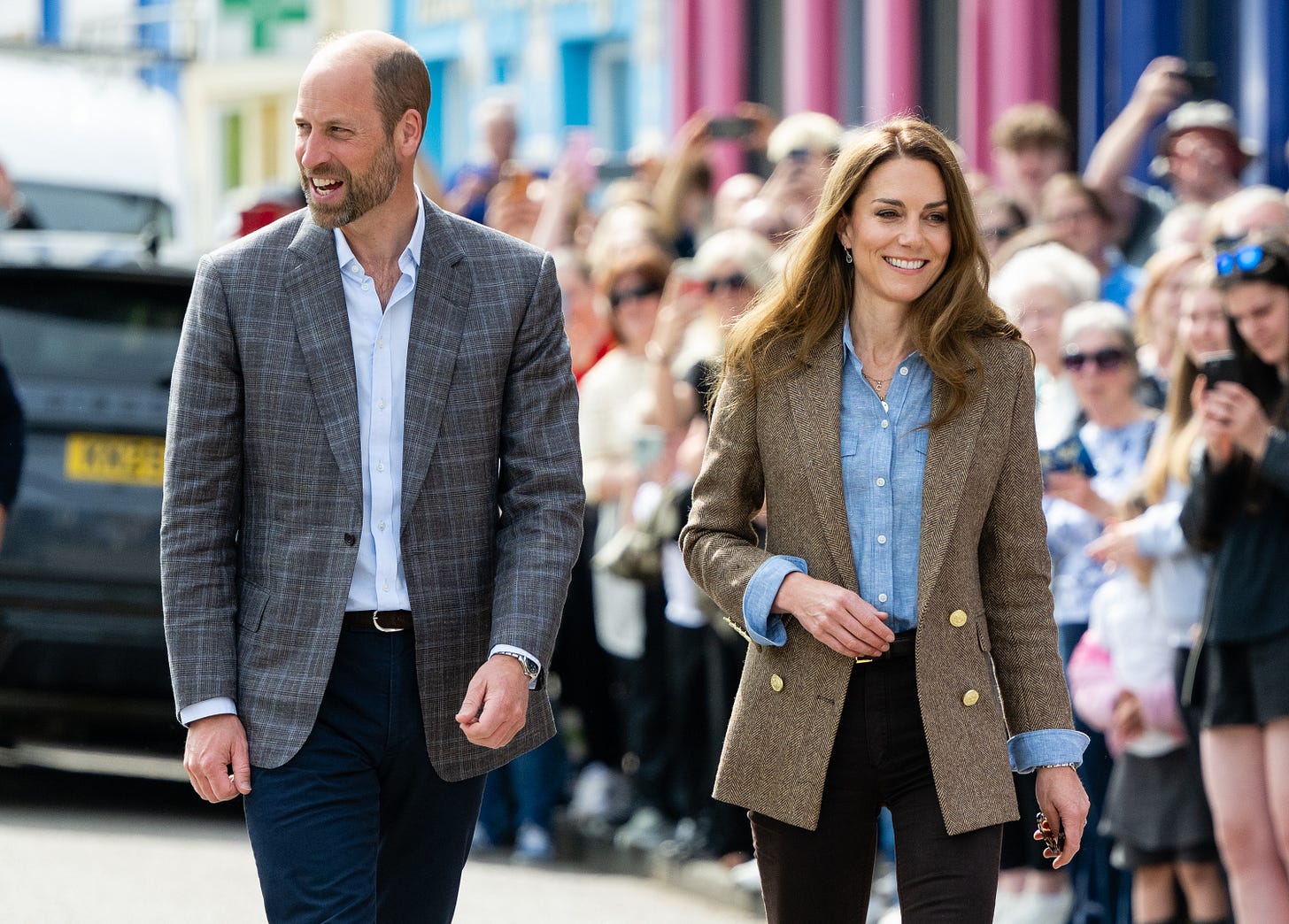 William and Catherine wearing checked blazers and blue shirts