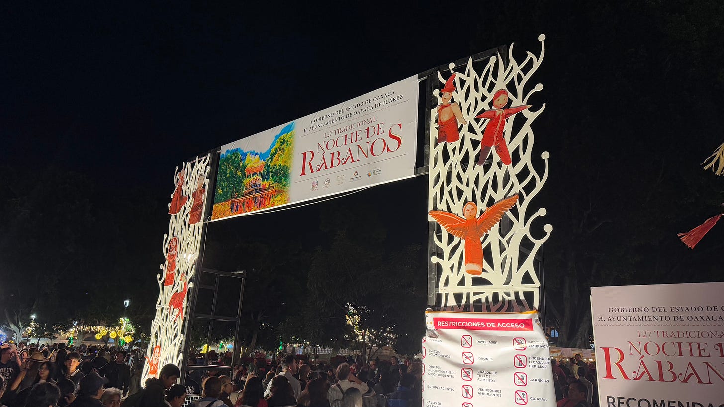 A large gateway with a banner labeled with the name Noche De Rabanos.