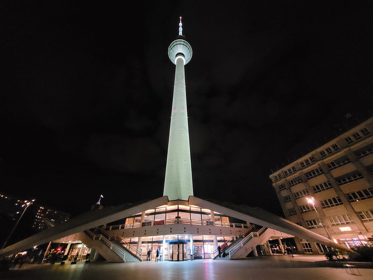 A very tall tower with a spherical structure near the top