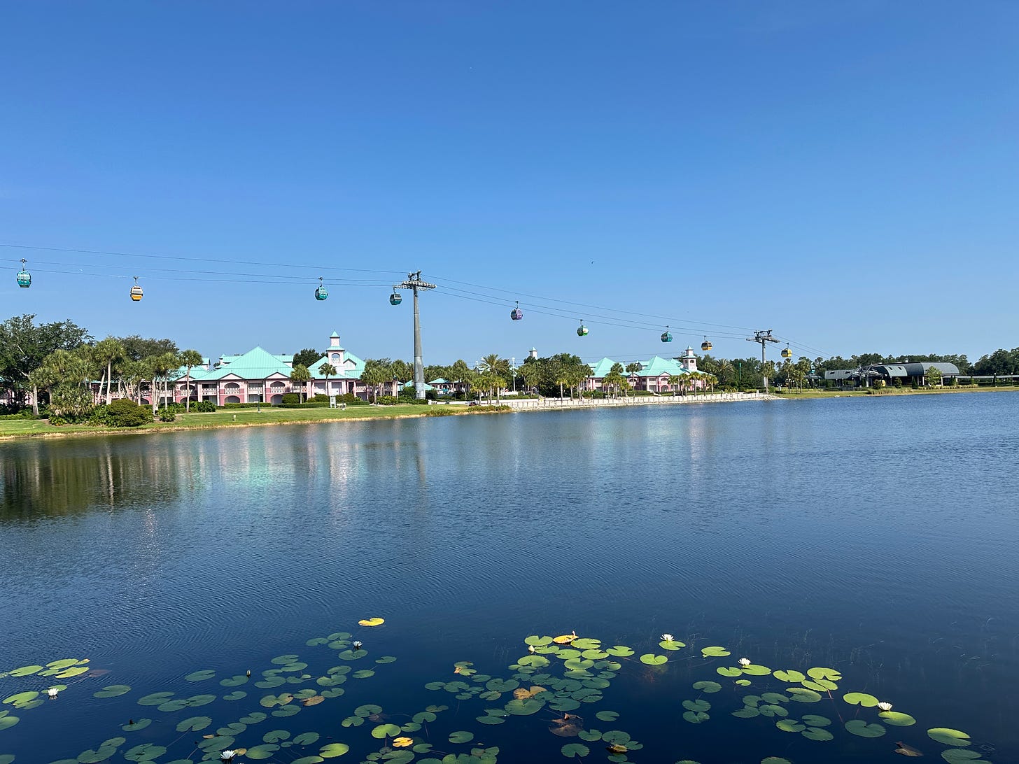 View across water of the Caribbean Beach Resort and Skyliner gondolas