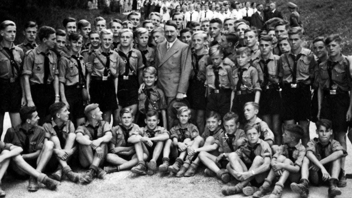 Adolf Hitler with Nazi party Hitler Youth at a 1935 gathering.