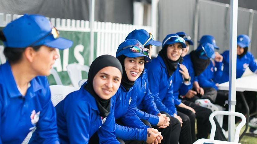 Firooza Amiri and other members of the Afghanistan women's team sit in team kit during their match against Cricket Without Borders Firooza Amiri and other members of the Afghanistan women's team sit in team kit during their match against Cricket Without Borders