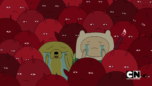 Finn and Jake from Adventure Time openly weeping with their hands in their faces in the middle of a dense crowd of little demon people.
