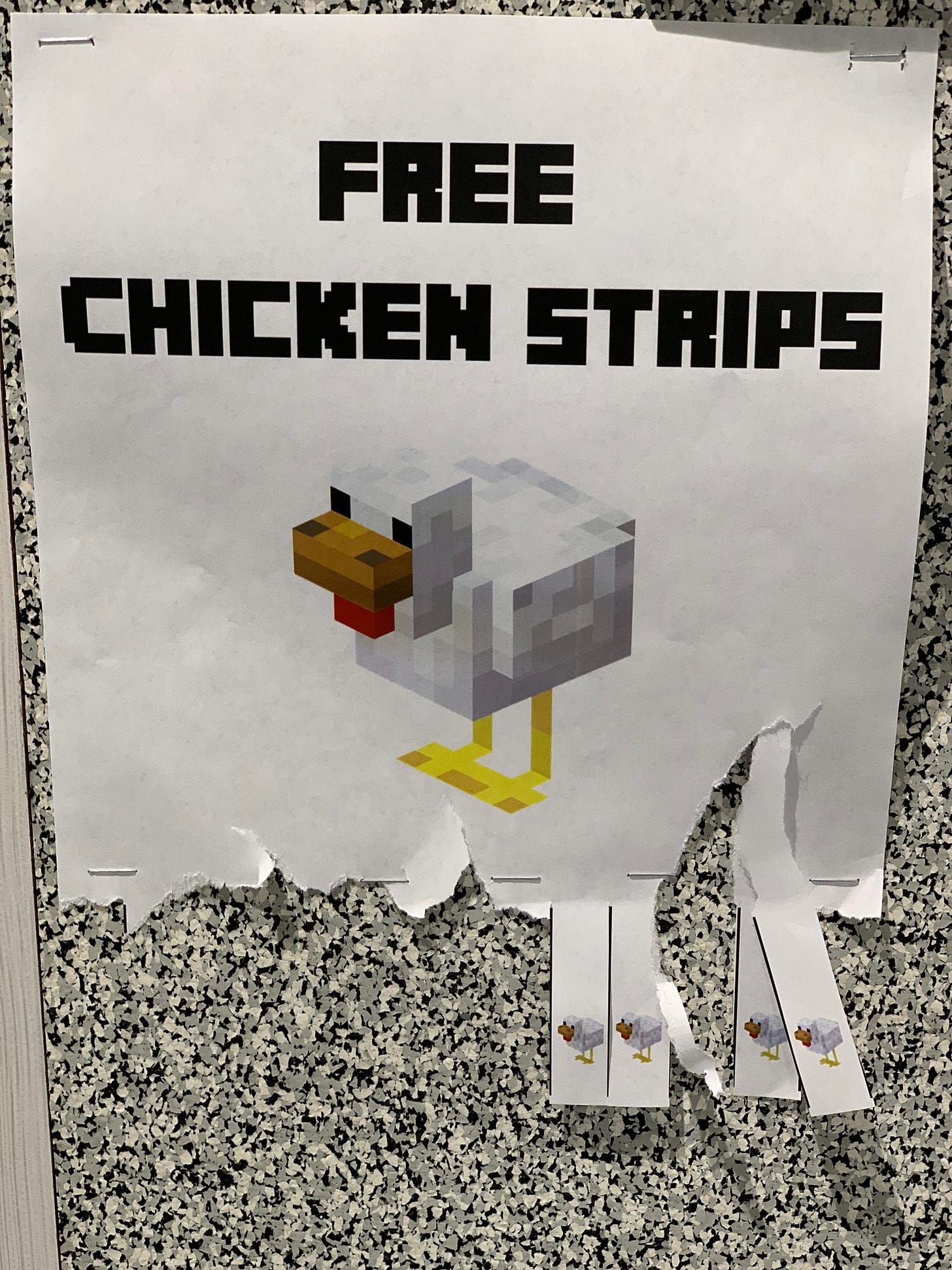 A picture of a pixelated chicken and the words Free Chicken Strips are on a white piece of paper. The bottom edge of the paper is cut into strips upon which is printed a smaller pixelated chicken, and most of the strips have been torn off.