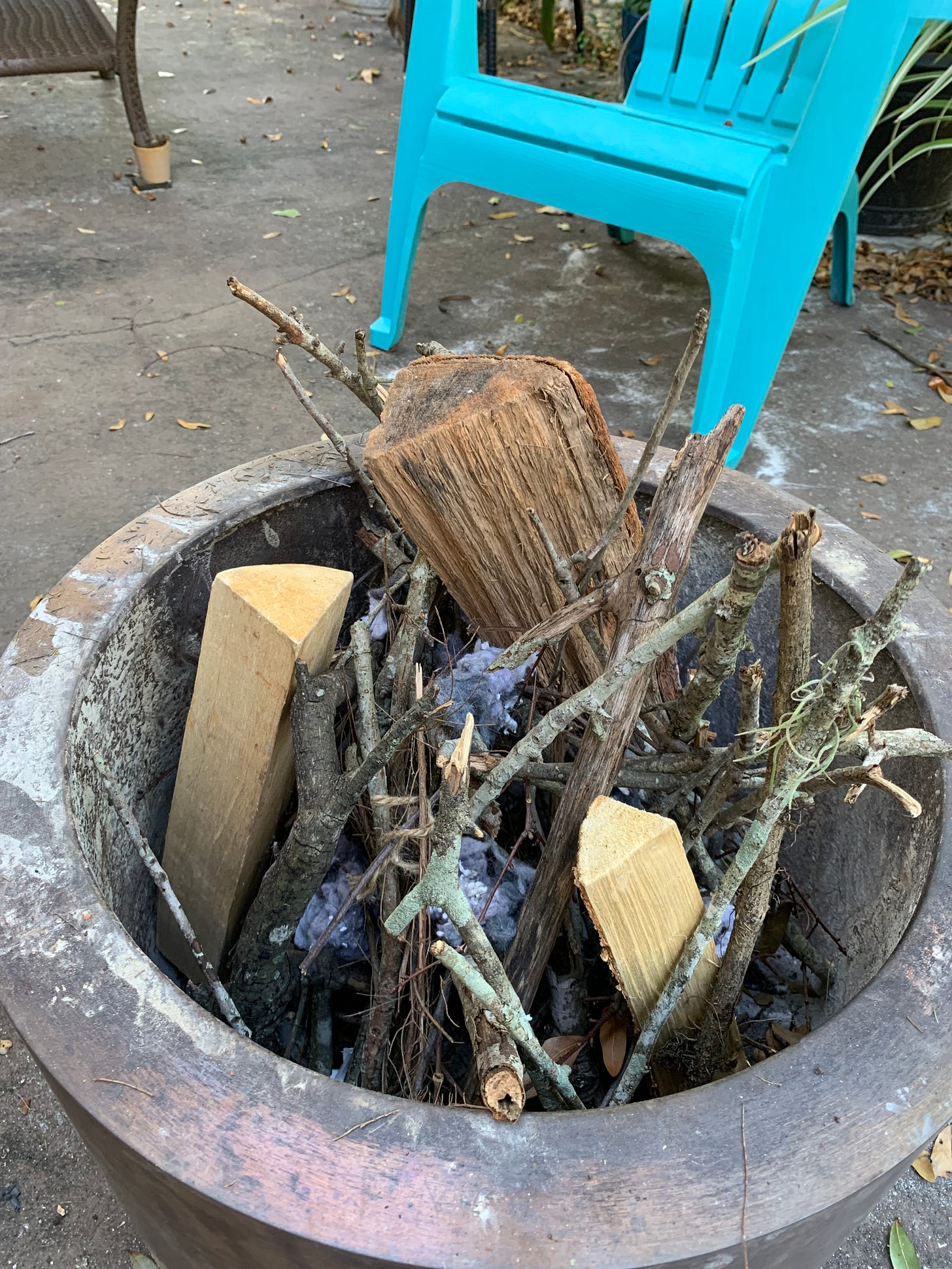 sticks and wood inside firepit, unlit