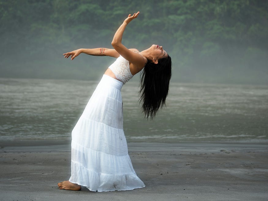 women in a white dress leaning back