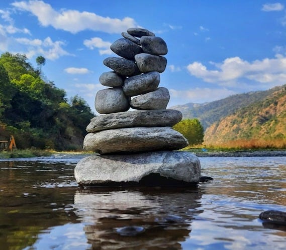 gray and black stone on water during daytime gray and black stone on water during daytime