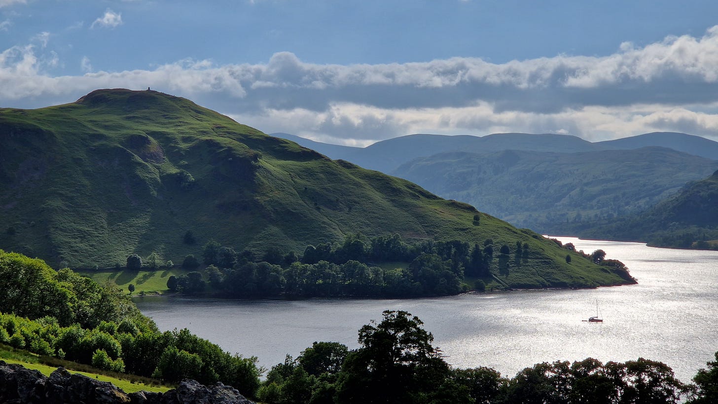 Green hill above a shimmering lake