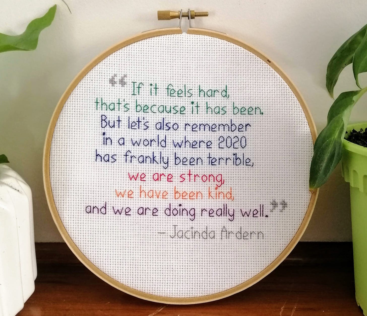 Cross stitch quote in a frame, text reads "If it feels hard right now, that's because it is. In a world where 2020 has frankly been terrible, we are strong, we have been kind, and we are doing really well." Jacinda Ardern
