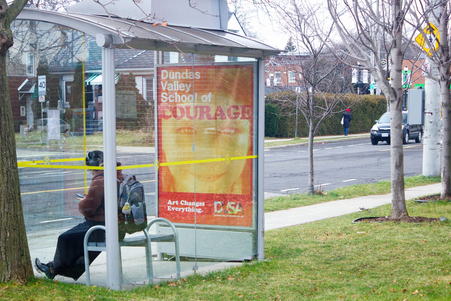 One of the DVSA bus ads. Main copy reads "Dundas Valley School of Courage" and shows a young child smiling.