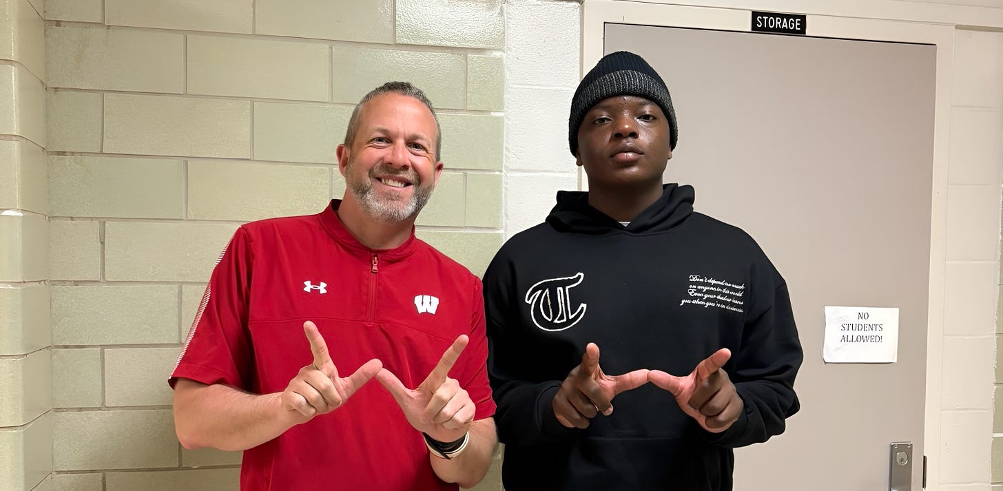 Wisconsin Badgers commit Djidjou Bah standing next to position coach Matt Mitchell during a recruiting visit
