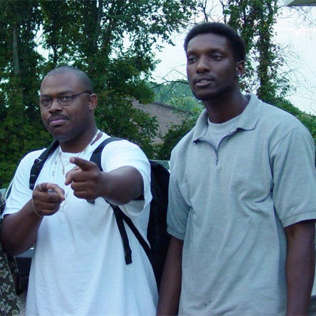 Myself pointing at the camera, standing next to friend and former group member, Correy G.