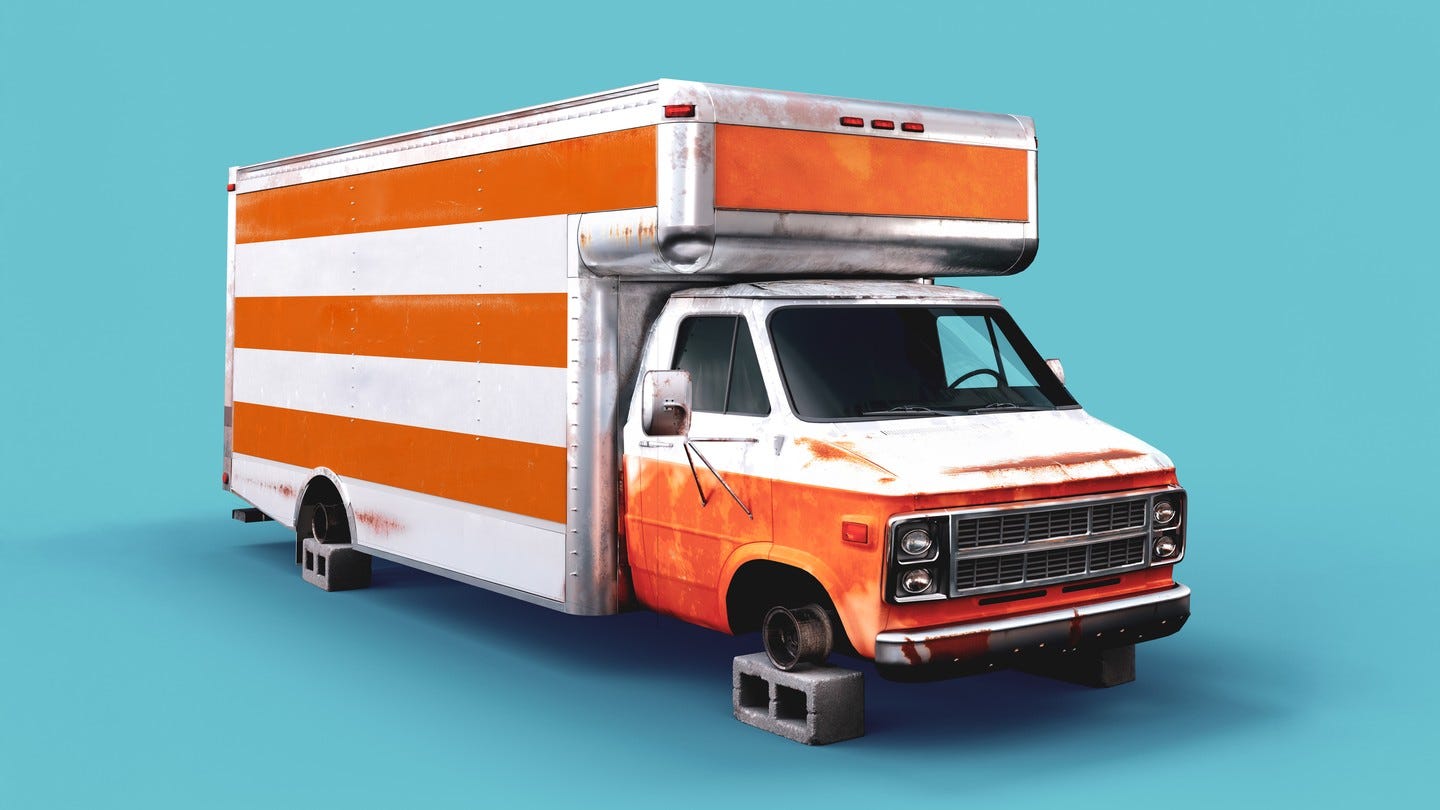 illustration of an old beat-up orange-and-white moving van with no wheels propped up on cinderblocks