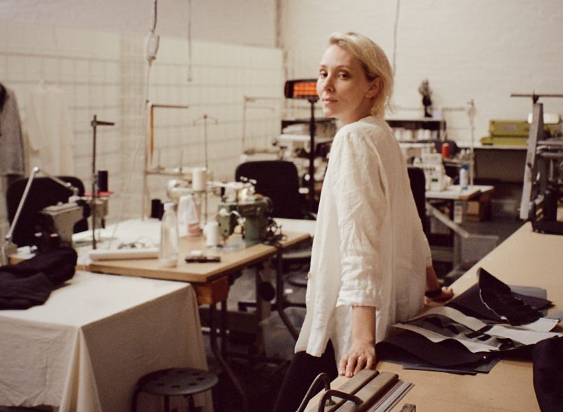 Courtney Holm stands in her circular factory, A.BCH and looks back at the camera