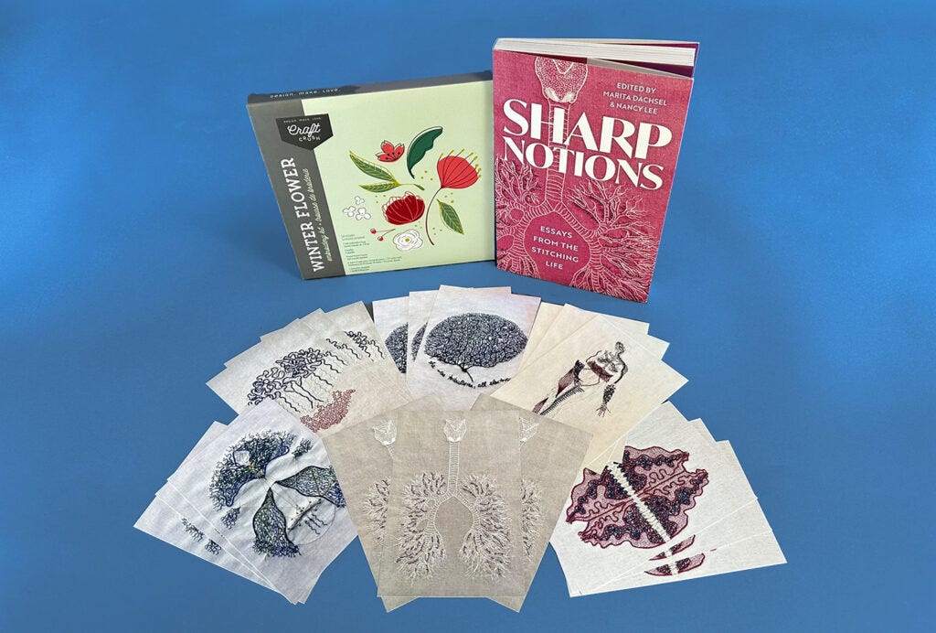 Against a vibrant blue background is a flatlay of 18 art postcards featuring the intricate embroidery creations of Lia Pas, next to DIY embroidery kit and a pink book called 'Sharp Notions: Essays from the Stitching Life' featuring a detail of Lia's embroidery on the cover