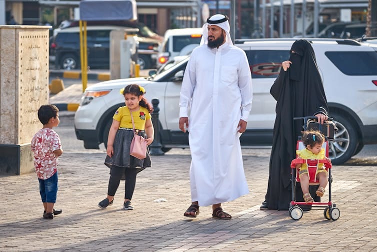 A family going for a walk in Kuwait.