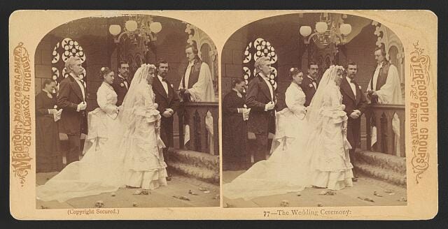 a photograph of a man and woman standing at an altar for a wedding. There are people standing beside them and church windows in the background