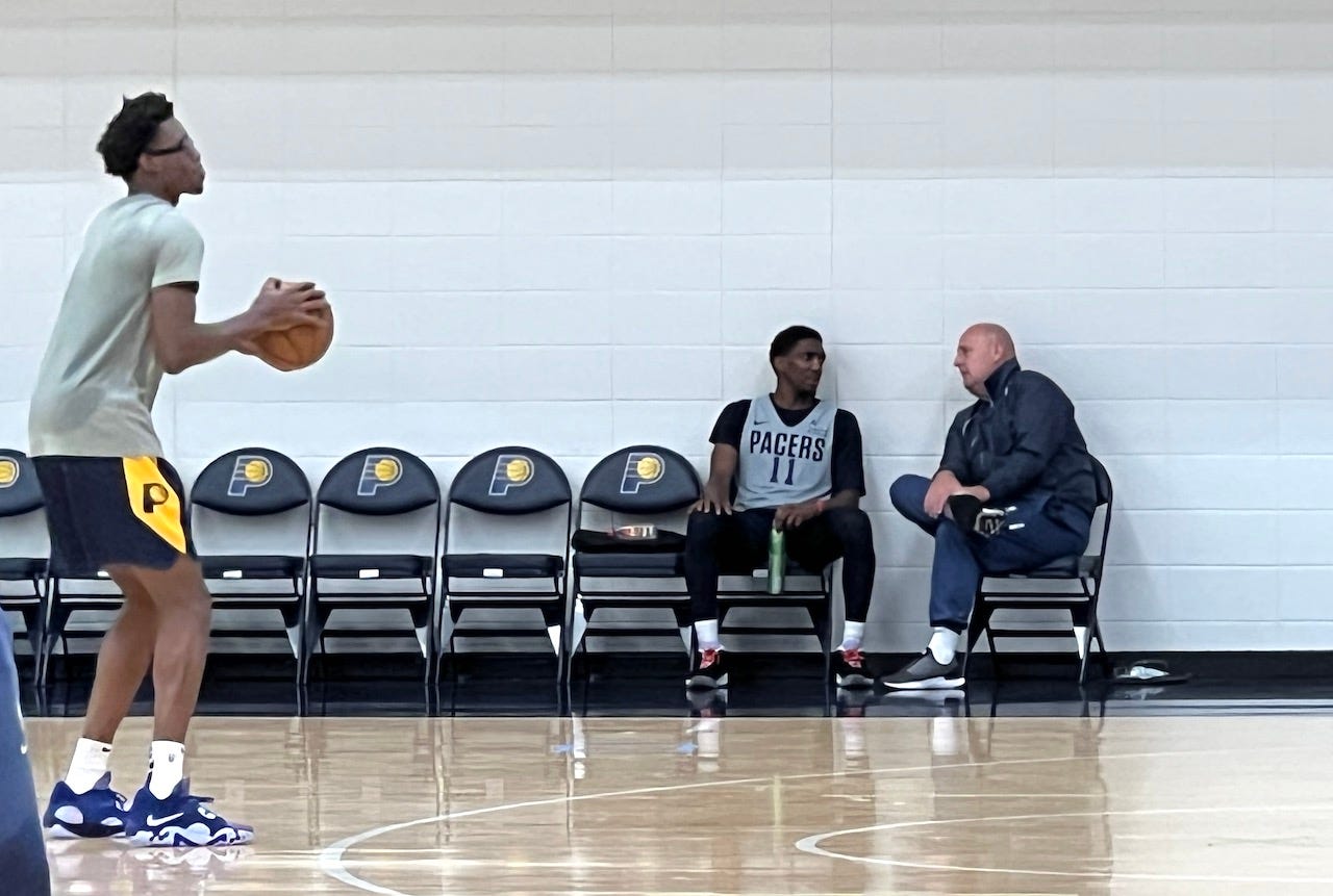 Jim Boylen talks with Langston Galloway after a training camp practice.