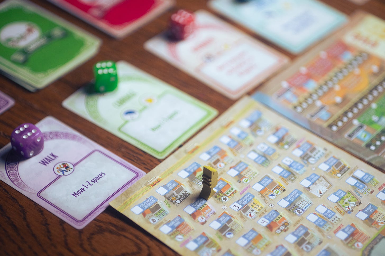 The roll-and-write game French Quarter being played on a wooden table.