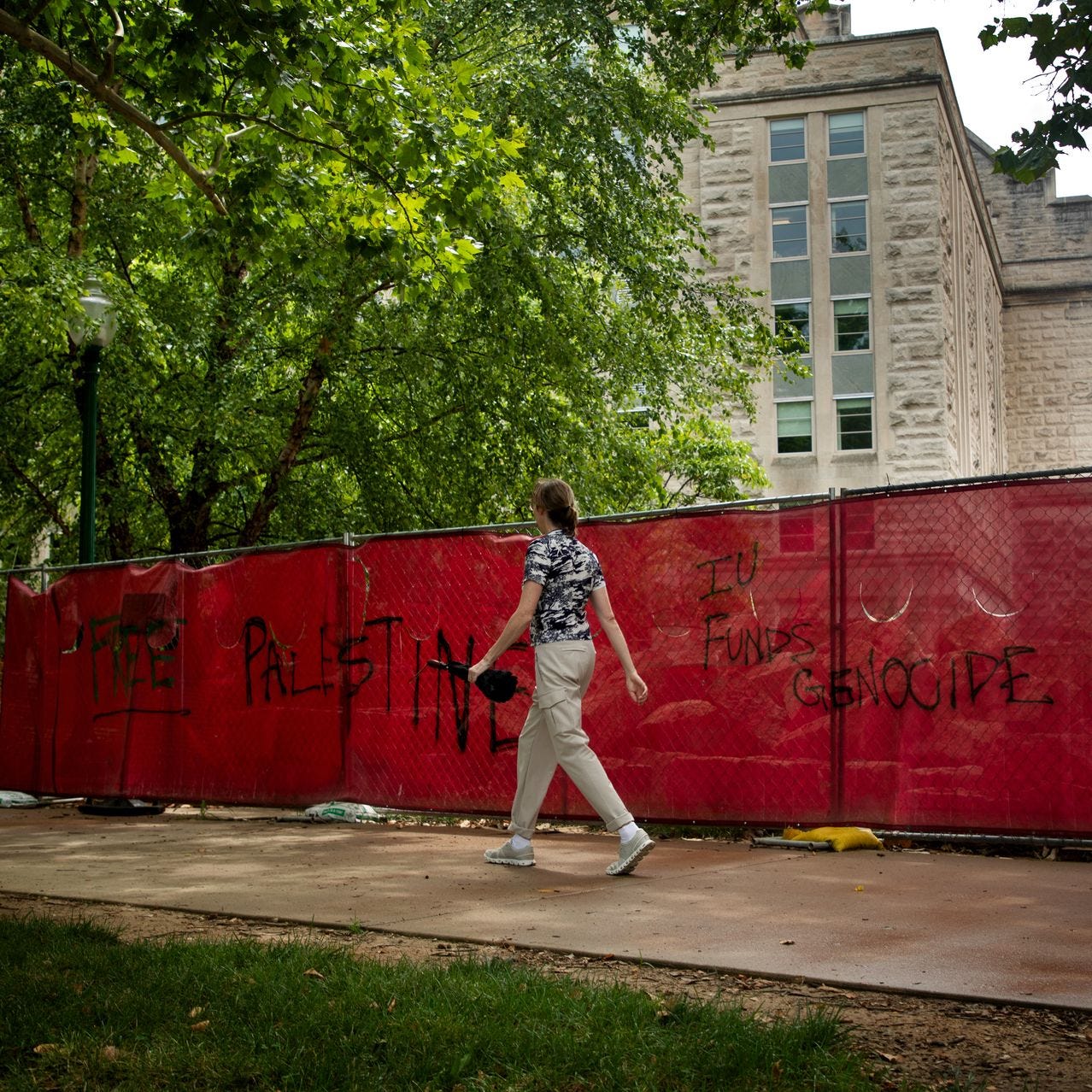 Protesters’ graffiti marked a fence on the campus of Indiana University in July.