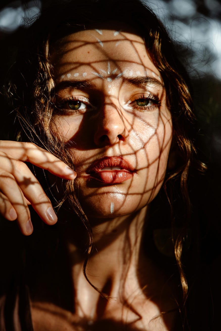 Eye of the storm. A woman with open eyes and shadows on her face. Eye of the storm. A woman with open eyes and shadows on her face.