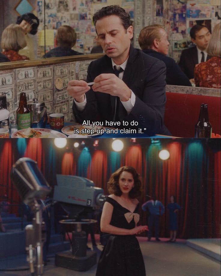This may contain: a man in a suit and tie sitting at a table next to a woman with a microphone