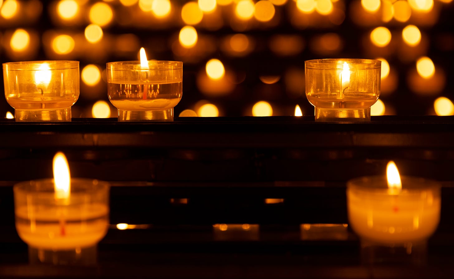 Photo of lighted candles in clear candle holders